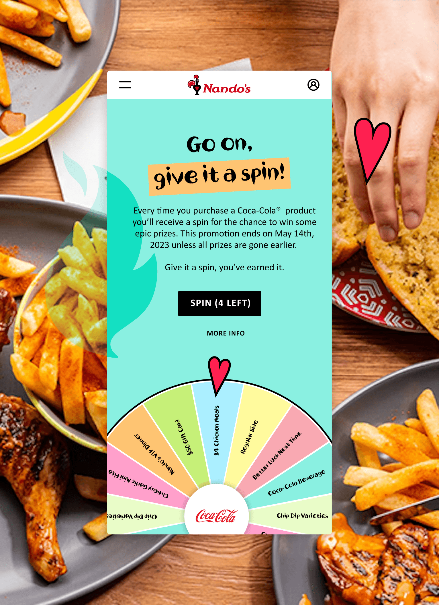 Table spread with Nando's food in background and spin to win game in foreground